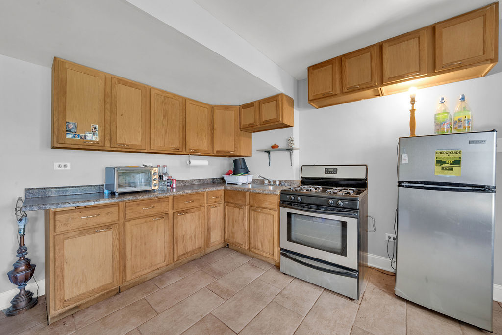 7245 West Dralle Road Monee, IL 60449 - Photo 9 of 73 a kitchen with stainless steel appliances granite countertop a sink and a refrigerator