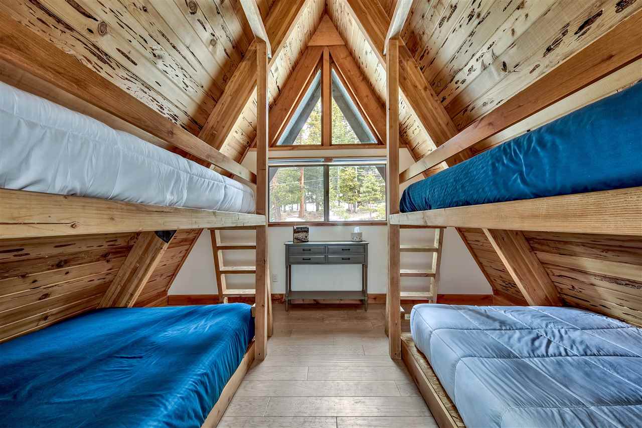 573 Granite Road Carnelian Bay, CA 96140 - Photo 16 of 21 a bedroom with a bed and a window