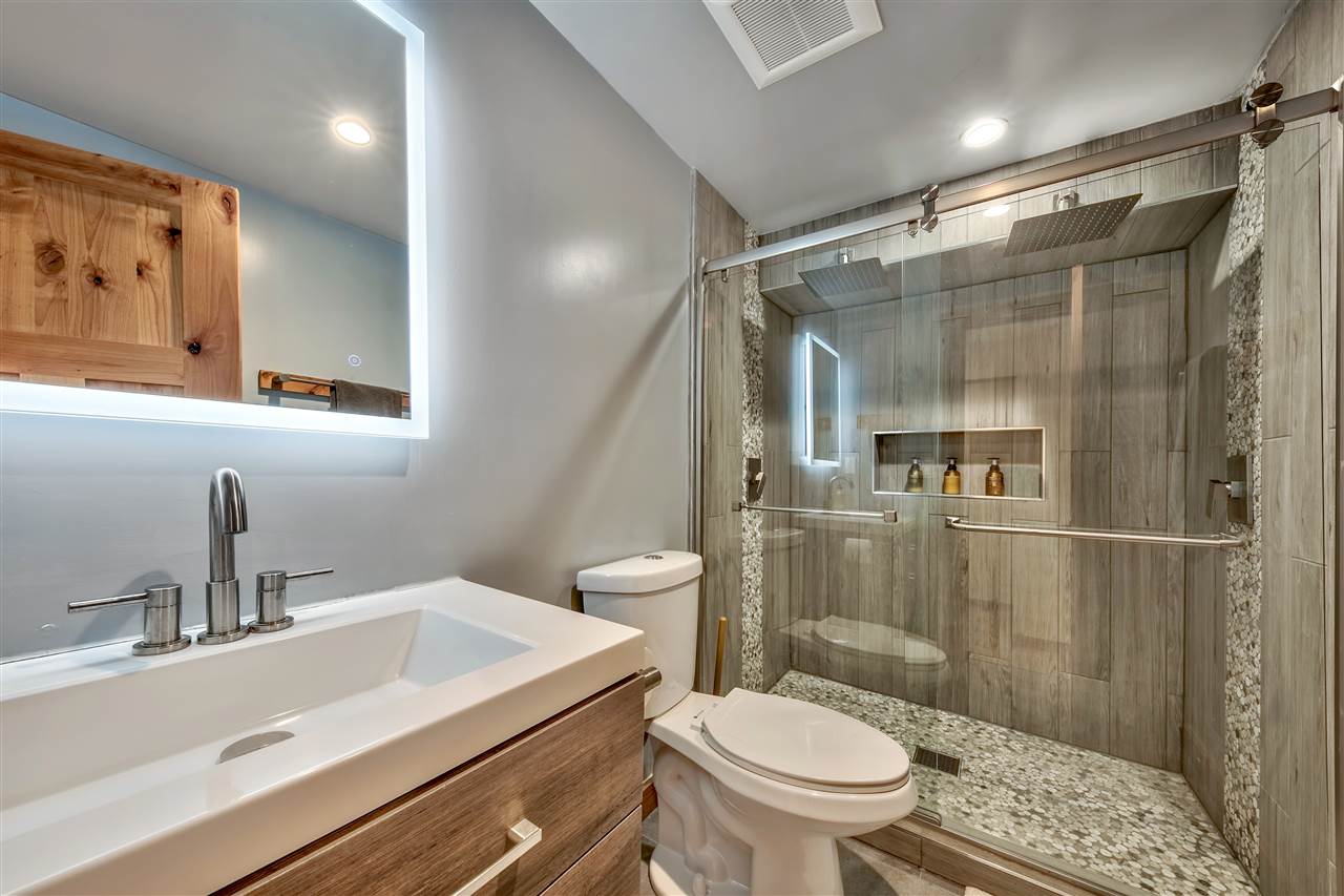 573 Granite Road Carnelian Bay, CA 96140 - Photo 18 of 21 a bathroom with a sink toilet and shower