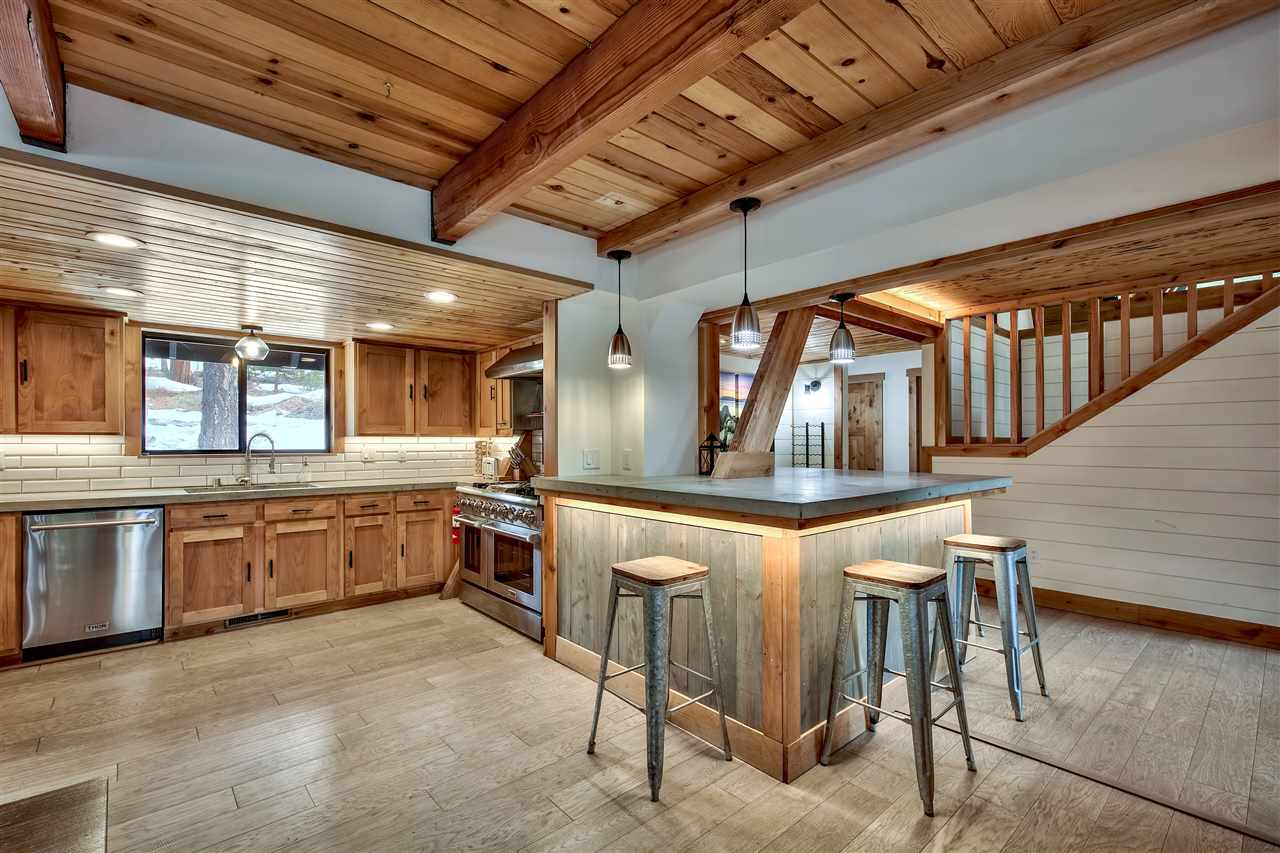 573 Granite Road Carnelian Bay, CA 96140 - Photo 9 of 21 a kitchen with stainless steel appliances granite countertop a sink and cabinets