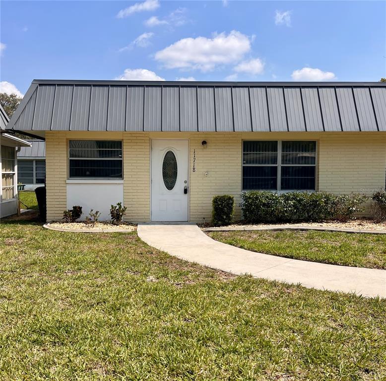 11718 Bayonet Lane, Unit A New Port Richey, FL 34654 - Photo 1 of 41 a front view of a house with garden