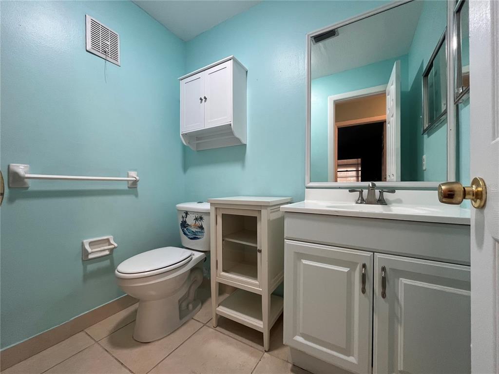 11718 Bayonet Lane, Unit A New Port Richey, FL 34654 - Photo 15 of 41 a bathroom with a toilet sink and mirror