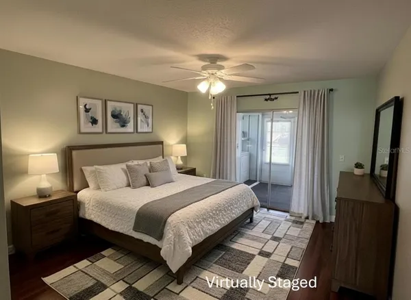 a bedroom with a large bed and a chandelier