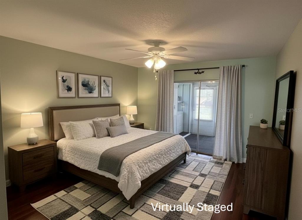 11718 Bayonet Lane, Unit A New Port Richey, FL 34654 - Photo 17 of 41 a bedroom with a large bed and a chandelier