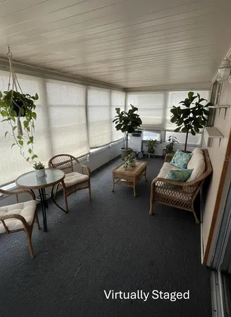 a living room with furniture and flowers