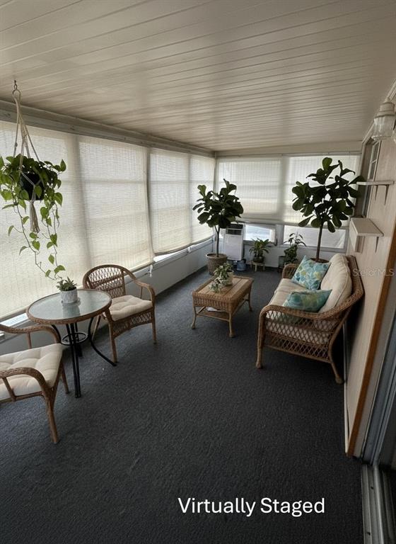 11718 Bayonet Lane, Unit A New Port Richey, FL 34654 - Photo 20 of 41 a living room with furniture and flowers