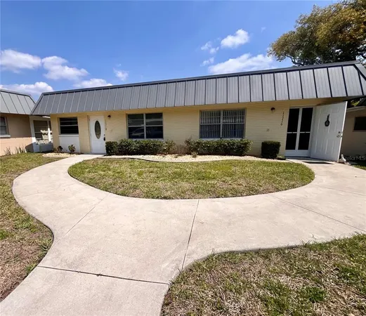 a view of a house with backyard and sitting area
