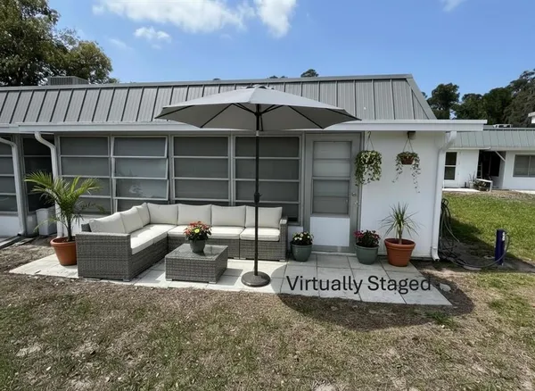 a view of a house with a patio and a fireplace
