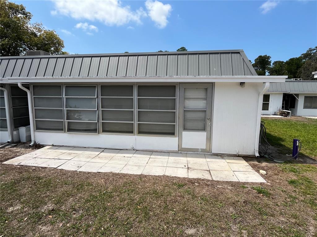 11718 Bayonet Lane, Unit A New Port Richey, FL 34654 - Photo 24 of 41 a front view of a house with a yard and garage