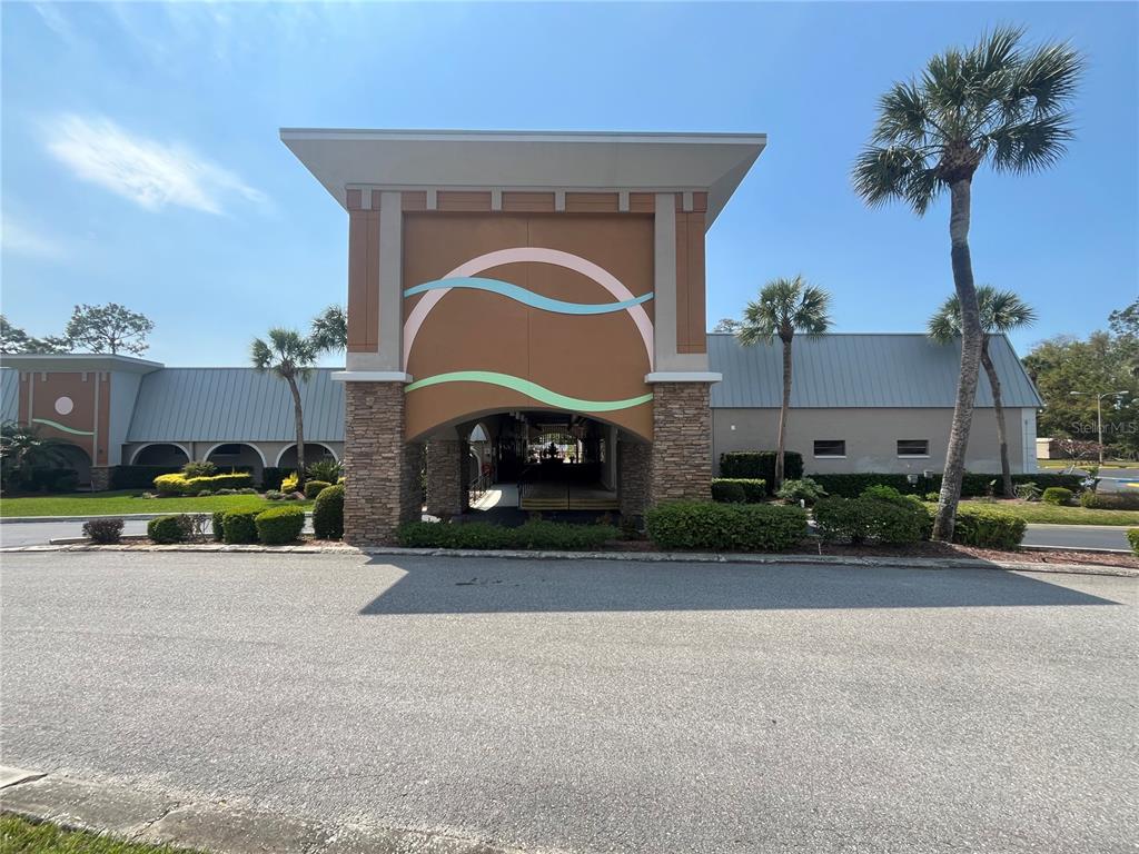 11718 Bayonet Lane, Unit A New Port Richey, FL 34654 - Photo 28 of 41 a front view of a house with a yard and a garage