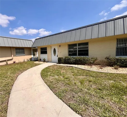 a swimming pool with outdoor seating and yard