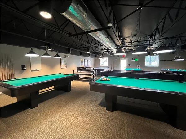 a room with pool table and a fireplace