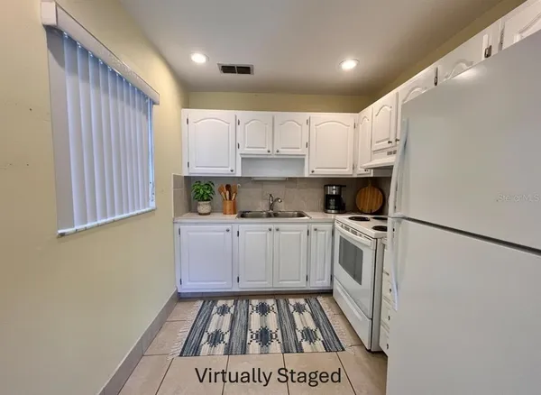 a kitchen with a white cabinets and white appliances
