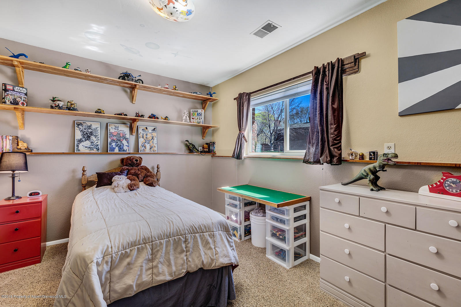 740 East 5th Street Rifle, CO 81650 - Photo 17 of 21 a bedroom with a bed a desk and chair