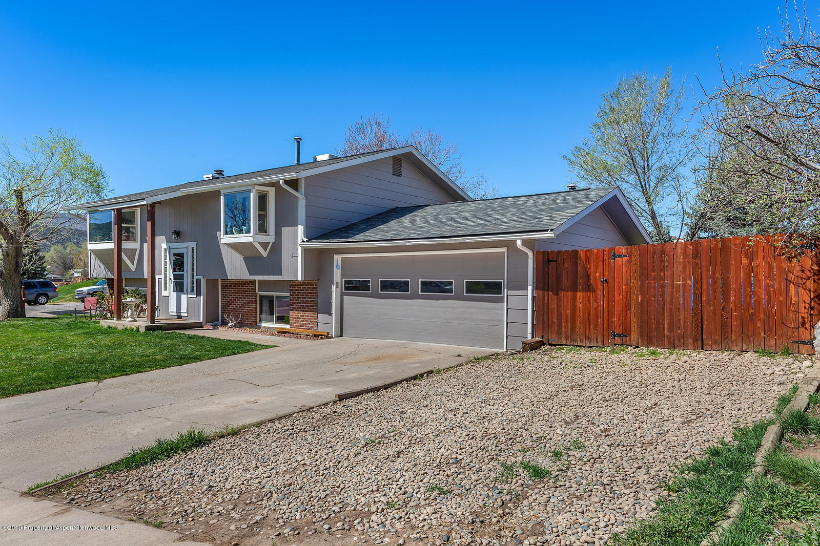 740 East 5th Street Rifle, CO 81650 - Photo 3 of 21 a front view of a house with a yard and garage