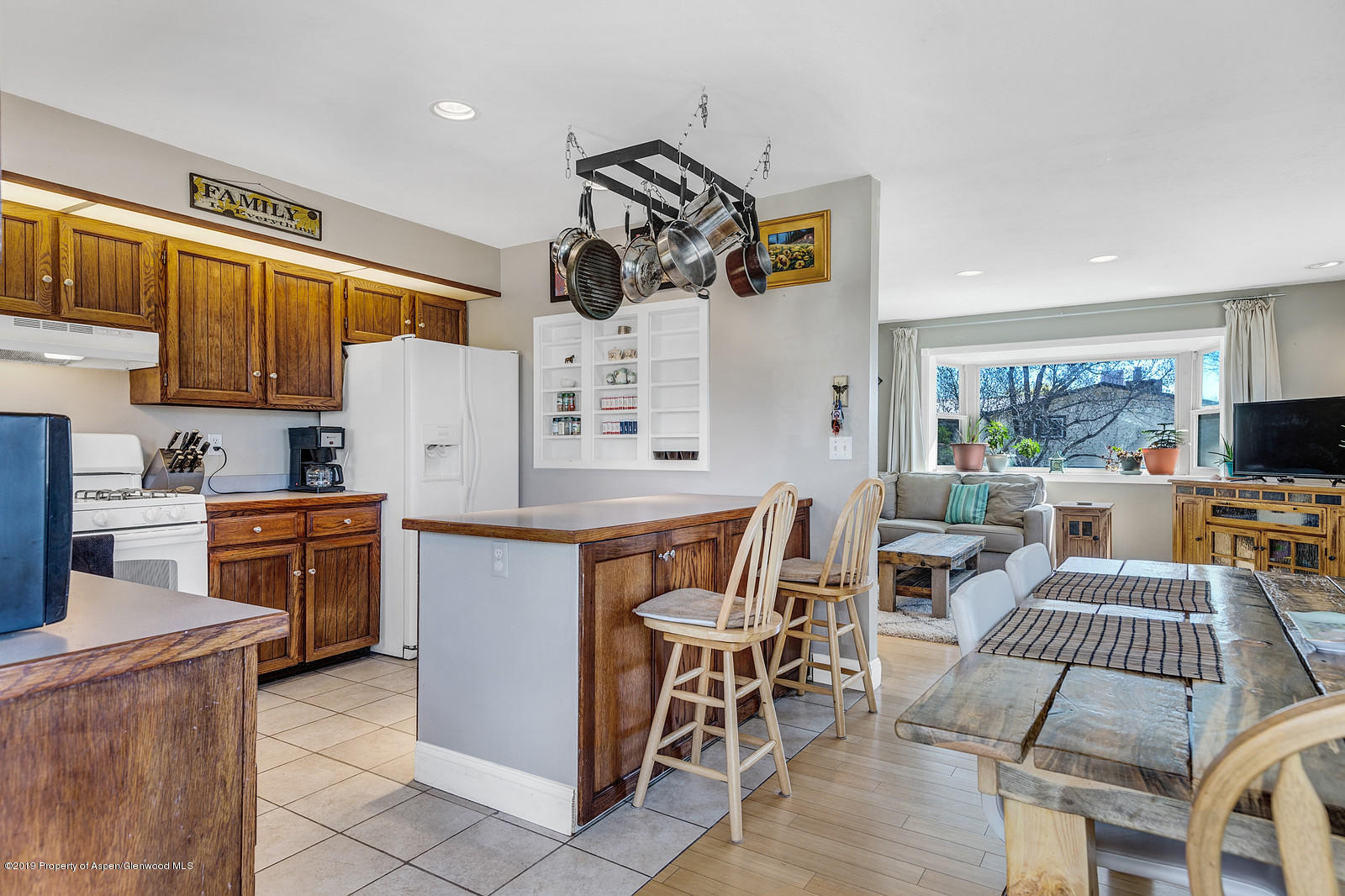 740 East 5th Street Rifle, CO 81650 - Photo 9 of 21 a kitchen with a table chairs microwave and cabinets