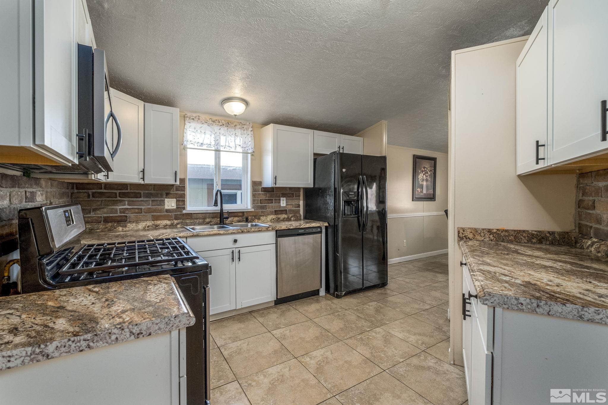 1670 Rockchuck Road Reno, NV 89506 - Photo 11 of 31 a kitchen with a refrigerator sink and stove