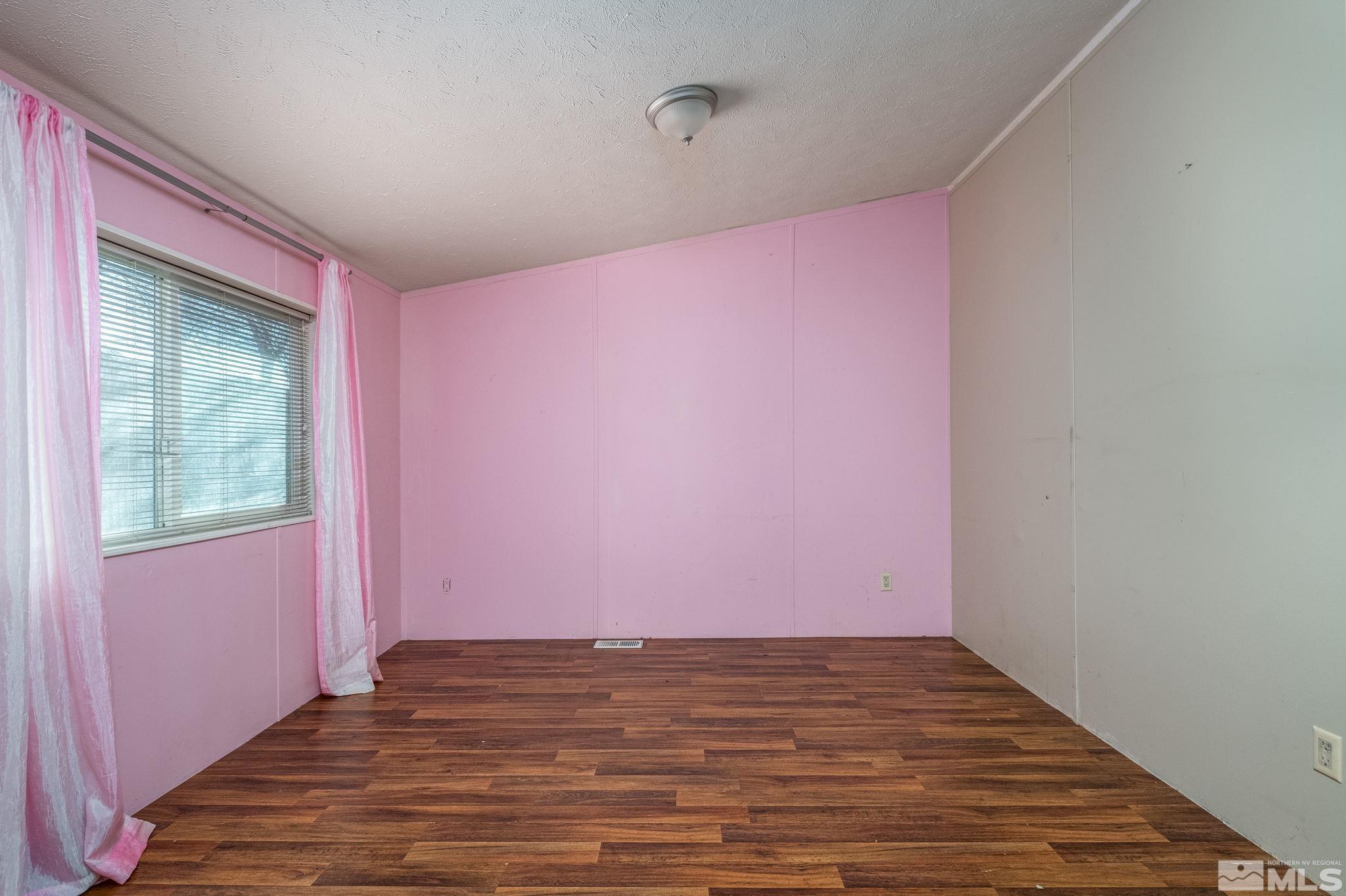1670 Rockchuck Road Reno, NV 89506 - Photo 14 of 31 a view of empty room with wooden floor and fan