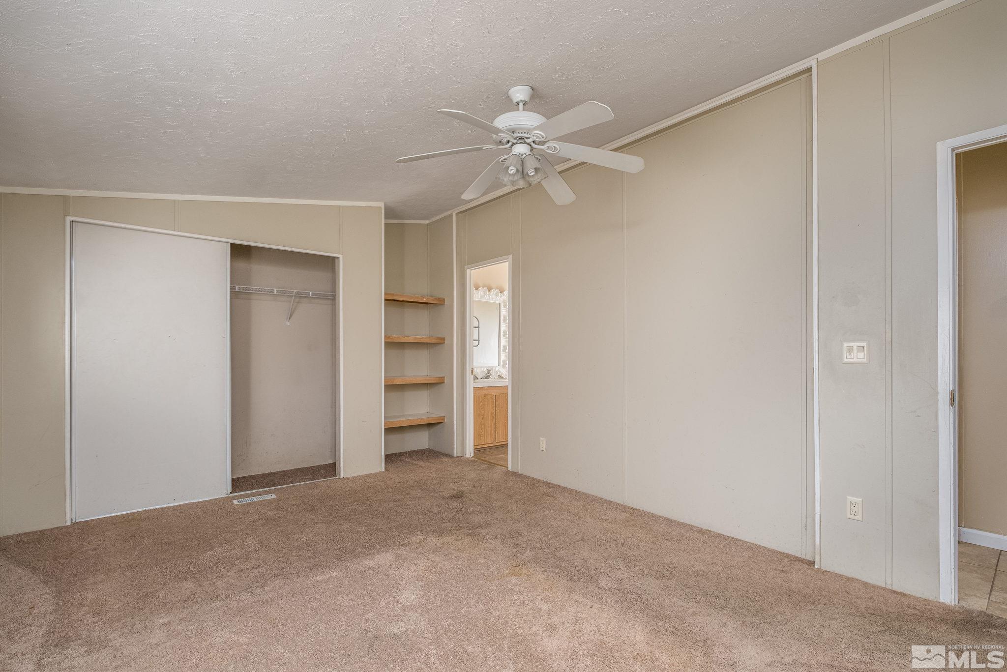 1670 Rockchuck Road Reno, NV 89506 - Photo 20 of 31 a view of a room with closet and a ceiling fan