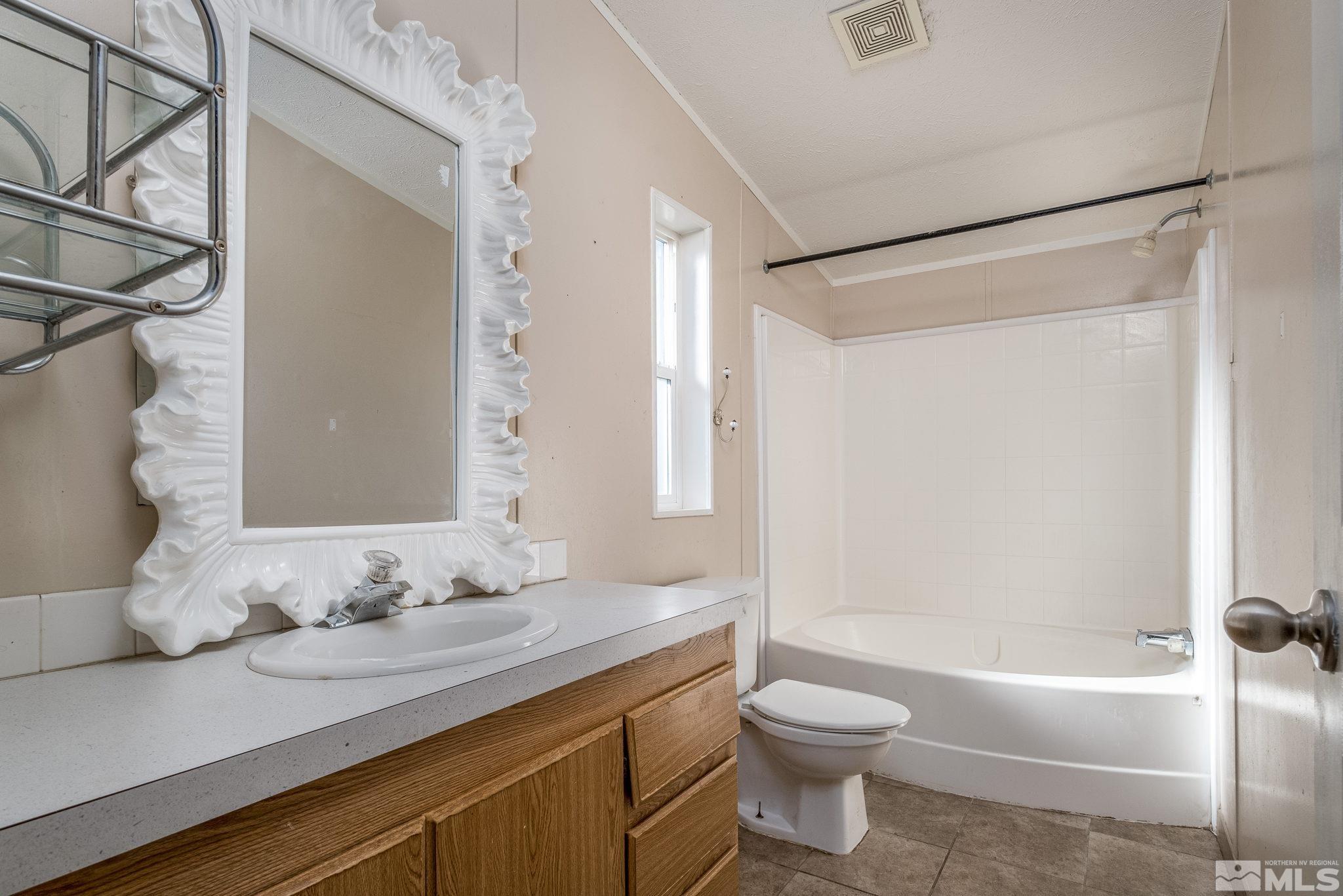 1670 Rockchuck Road Reno, NV 89506 - Photo 21 of 31 a bathroom with a granite countertop sink toilet and shower
