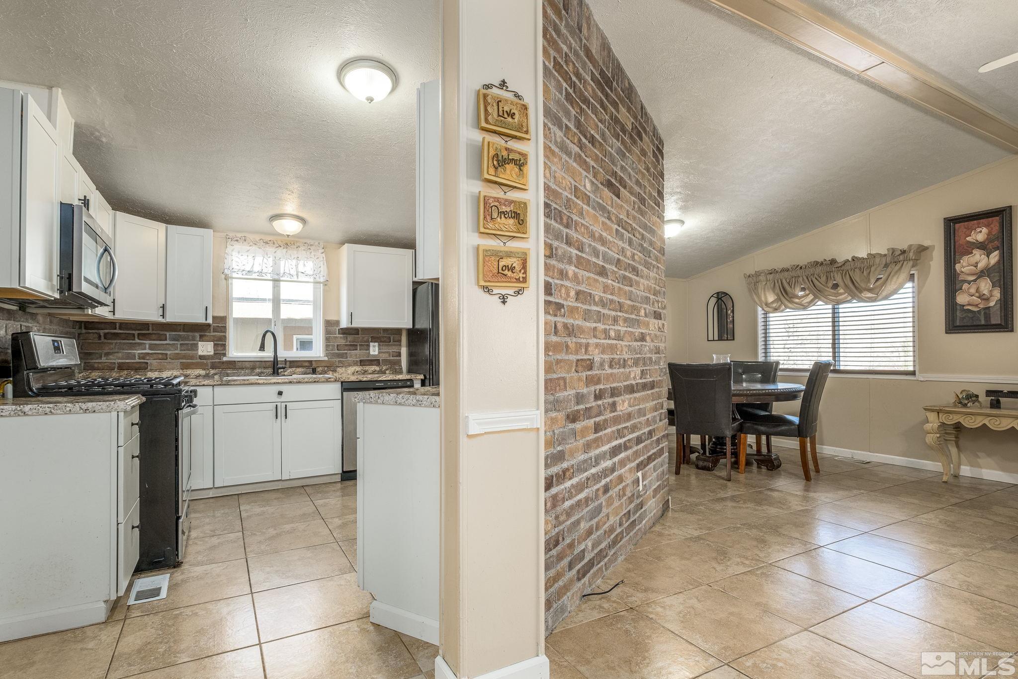 1670 Rockchuck Road Reno, NV 89506 - Photo 23 of 31 a kitchen with a cabinets and chairs