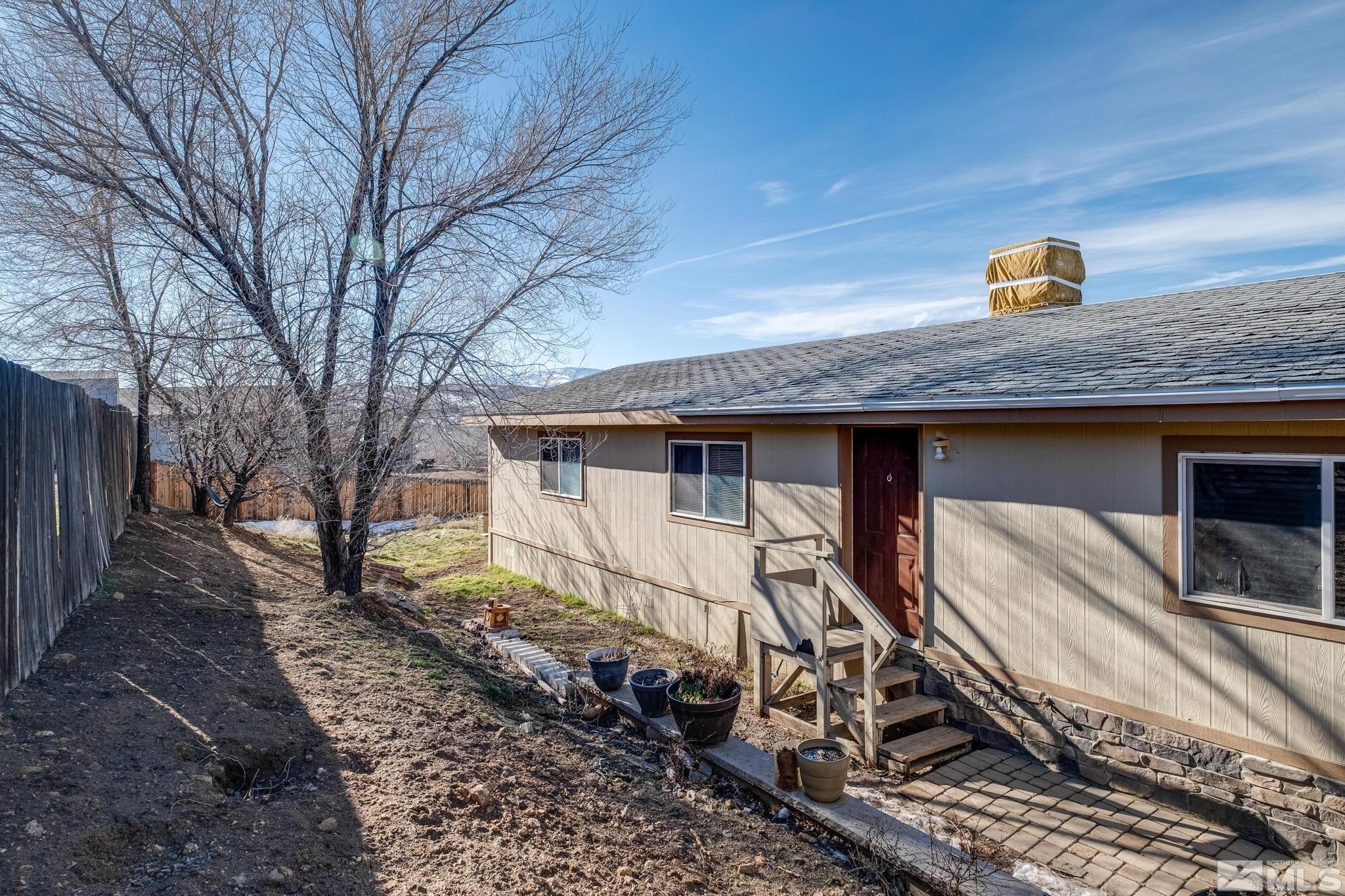 1670 Rockchuck Road Reno, NV 89506 - Photo 28 of 31 a view of a wooden house with a large tree