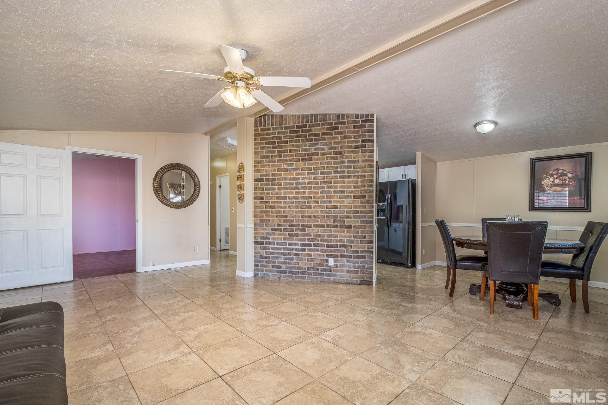 1670 Rockchuck Road Reno, NV 89506 - Photo 3 of 31 a view of a livingroom with furniture and a fan
