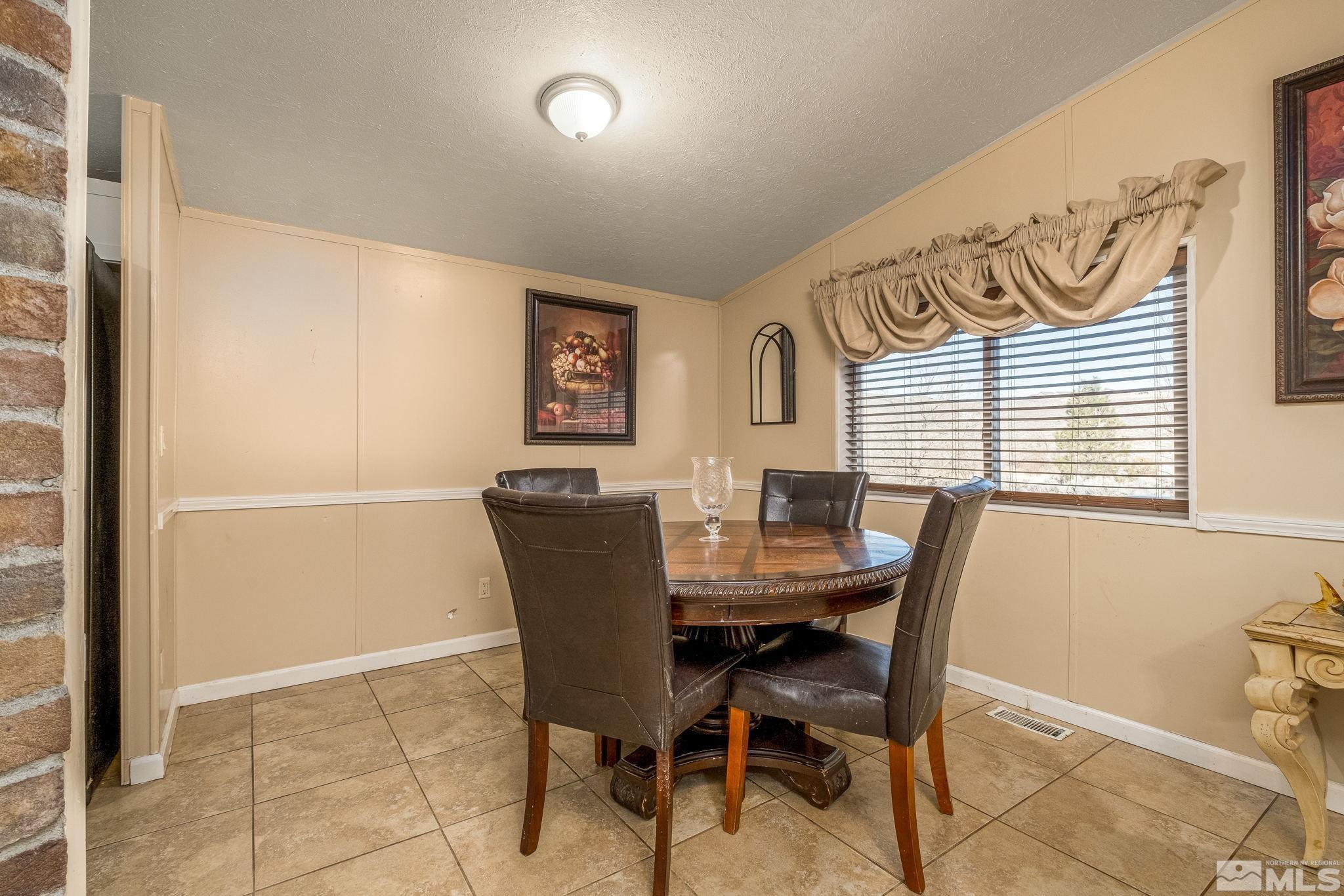 1670 Rockchuck Road Reno, NV 89506 - Photo 5 of 31 a view of a dining room with furniture and window