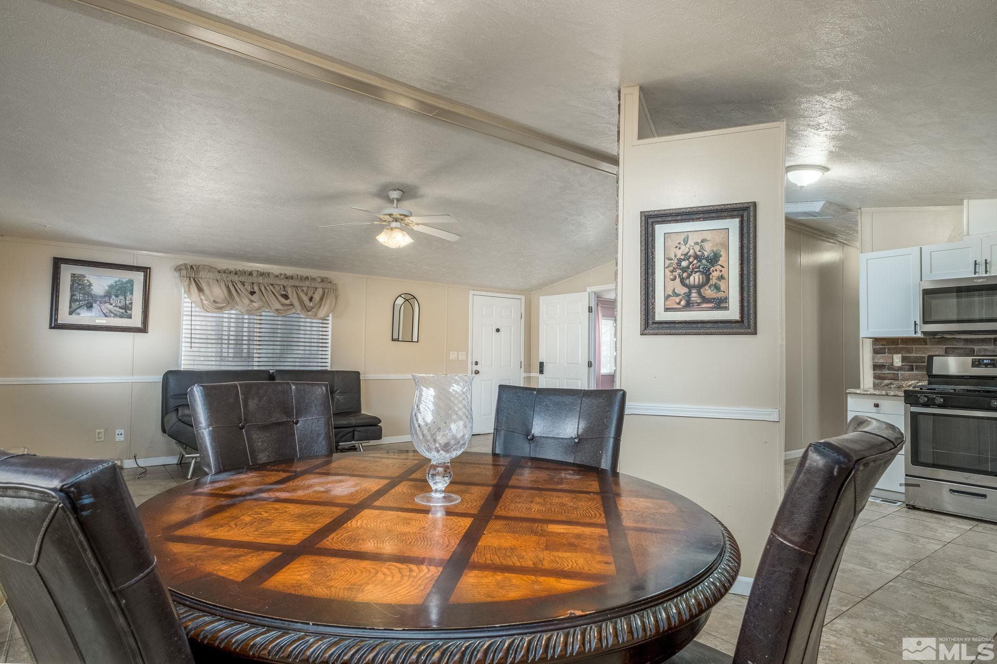 1670 Rockchuck Road Reno, NV 89506 - Photo 6 of 31 a room with furniture a flat screen tv and kitchen view