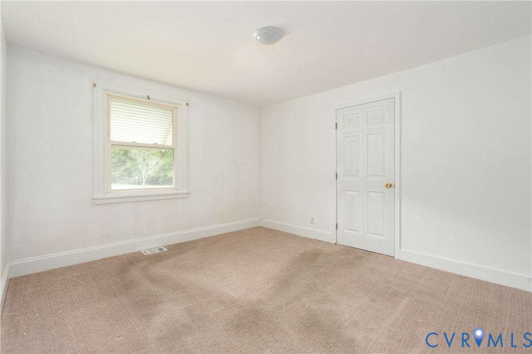 4000 Wayside Road Charles City, VA 23030 - Photo 11 of 30 Neutral tone wall finish, light-colored carpeting,