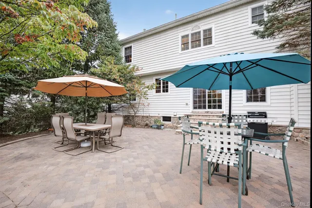 a view of backyard with outdoor seating and wooden floor