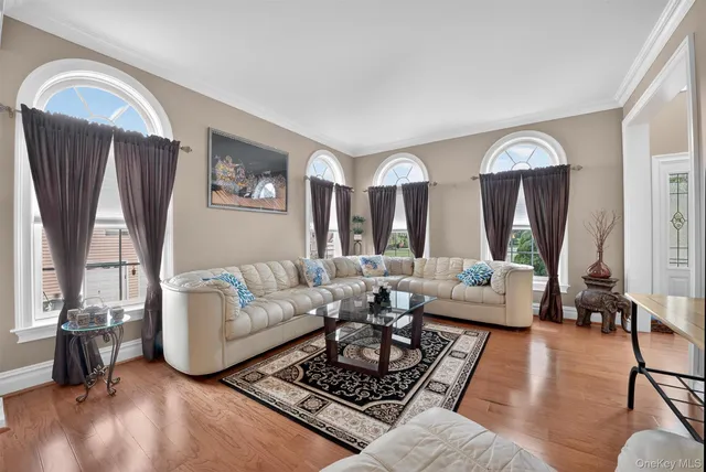 a living room with furniture fireplace and a large window