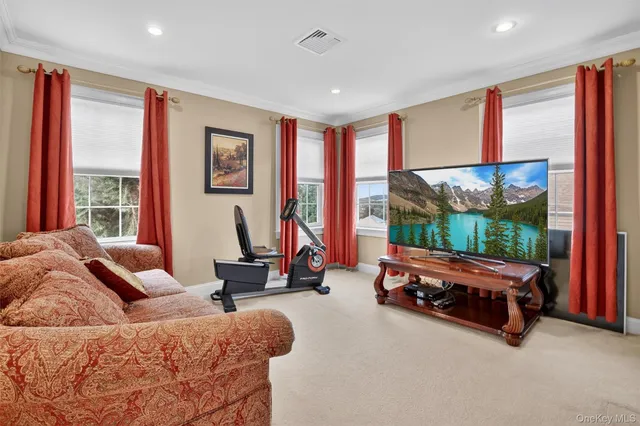 a living room with furniture and large windows