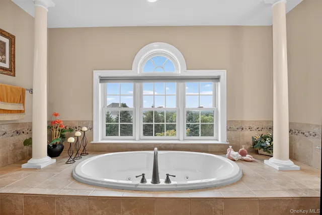 a bath tub sitting in a bathroom next to a window