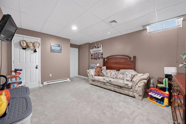 a view of a dining room with furniture a potted plant and wooden floor