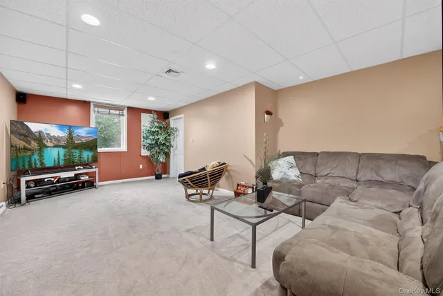 a view of a livingroom with furniture and a potted plant