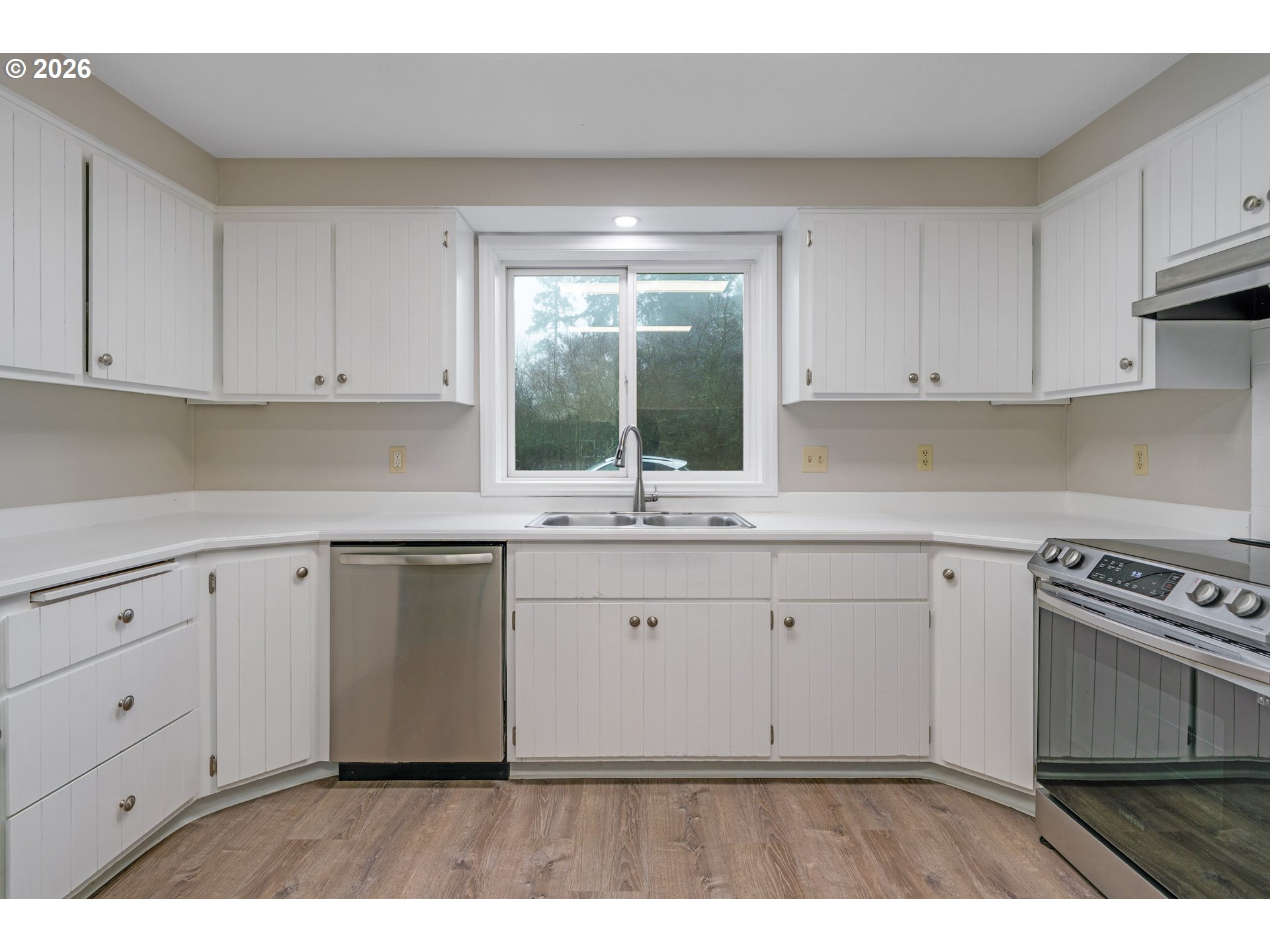 17839 Southwest Meadowbrook Way Beaverton, OR 97078 - Photo 12 of 45 a kitchen with white cabinets appliances and a sink