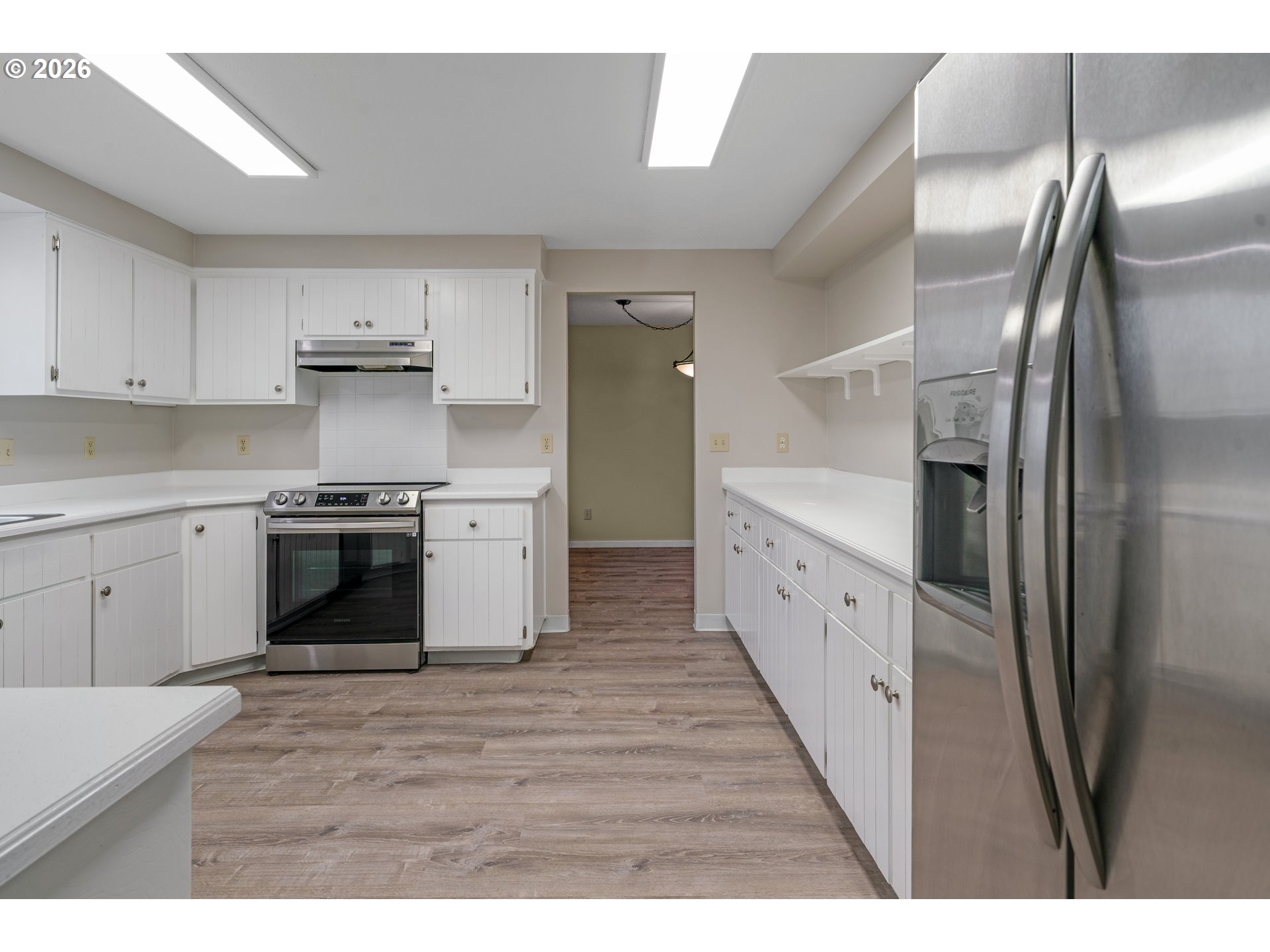 17839 Southwest Meadowbrook Way Beaverton, OR 97078 - Photo 13 of 45 a large kitchen with stainless steel appliances granite countertop a refrigerator a sink a stove and white cabinets