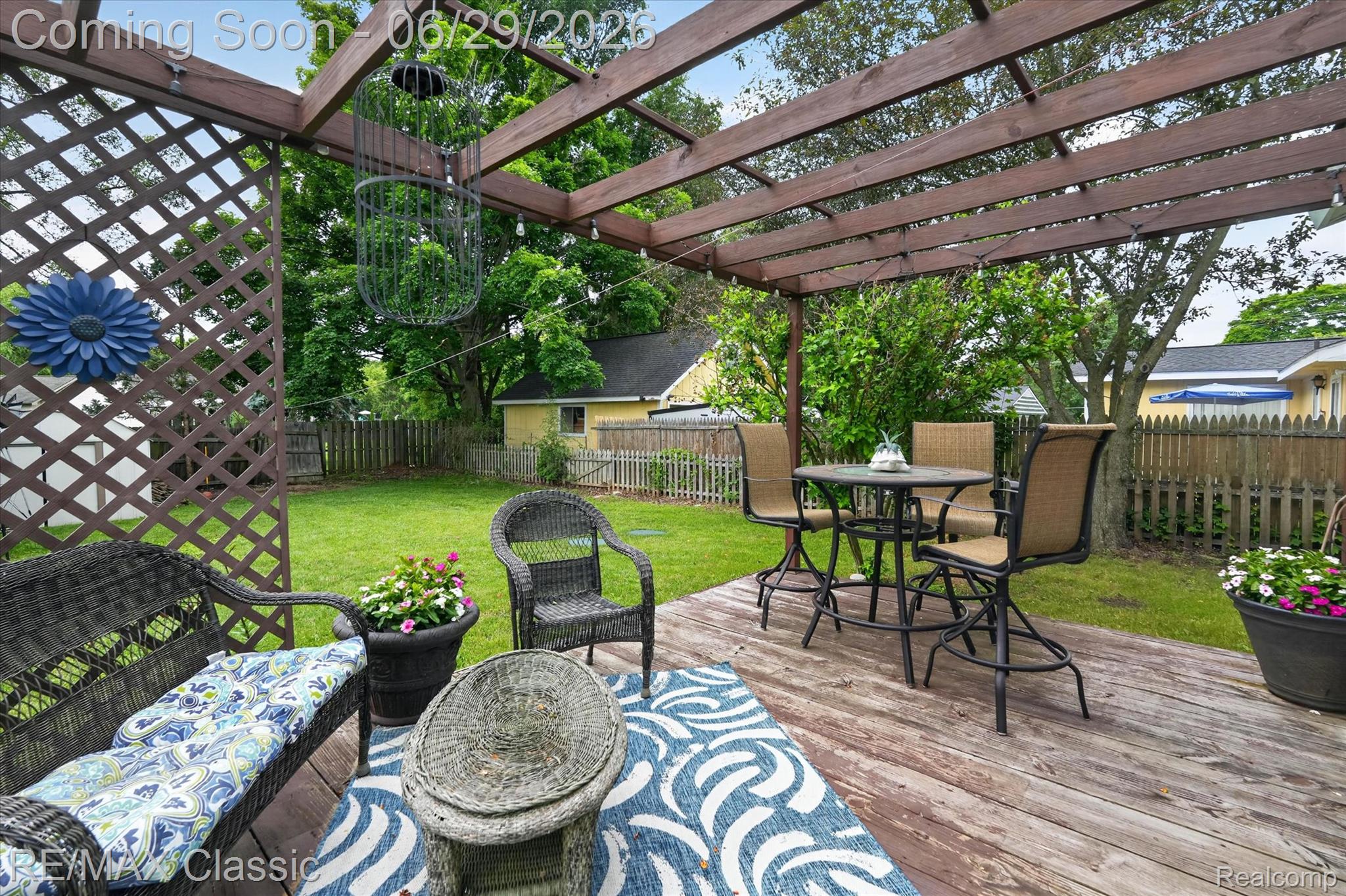 352 Meribah Road Highland, MI 48356 - Photo 31 of 39 Expansive backyard deck featuring a wooden pergola and lattice privacy screen