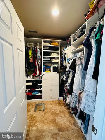 a kitchen with stainless steel appliances kitchen island granite countertop a stove a sink and a refrigerator