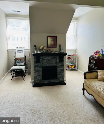 a living room with furniture a ceiling fan and a rug