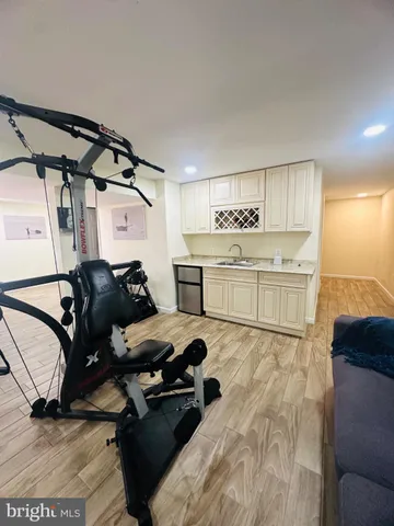a balcony with wooden floor table and chairs