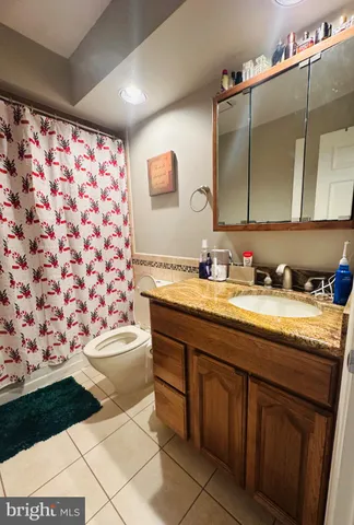 a bathroom with a granite countertop sink a vanity and a shower