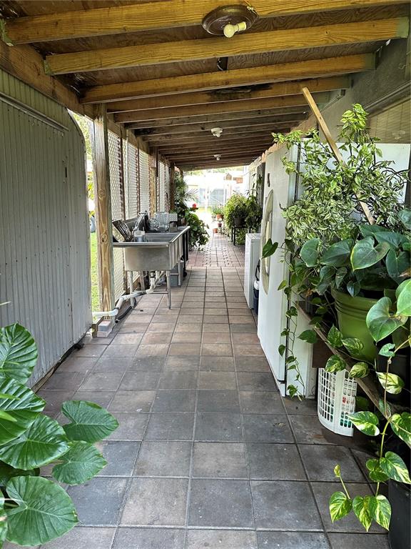 1326 Northeast Forrest Avenue Arcadia, FL 34266 - Photo 18 of 26 a view of a patio with table and chairs with potted plants