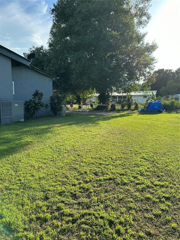 1326 Northeast Forrest Avenue Arcadia, FL 34266 - Photo 19 of 26 a view of a large pool with lawn chairs under an umbrella