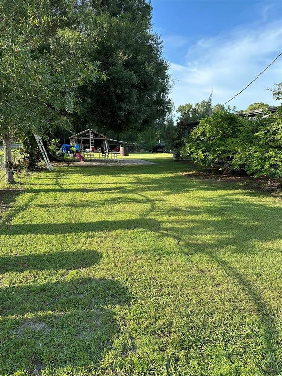1326 Northeast Forrest Avenue Arcadia, FL 34266 - Photo 25 of 26 a front view of a house with a yard