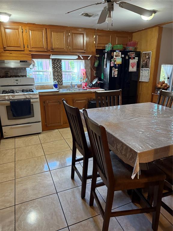 1326 Northeast Forrest Avenue Arcadia, FL 34266 - Photo 6 of 26 a kitchen with stainless steel appliances kitchen island granite countertop a table chairs sink and cabinets