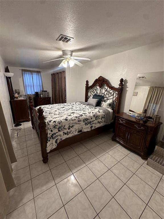 1326 Northeast Forrest Avenue Arcadia, FL 34266 - Photo 9 of 26 a bedroom with a bed and a chandelier
