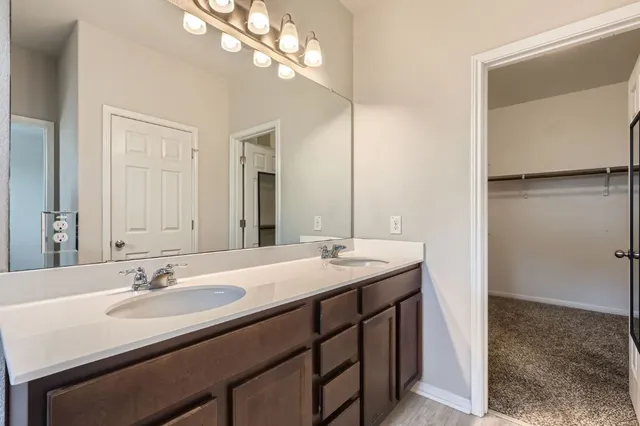 a bathroom with a sink double vanity and a mirror