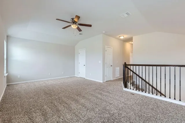 a view of a hallway with a ceiling fan